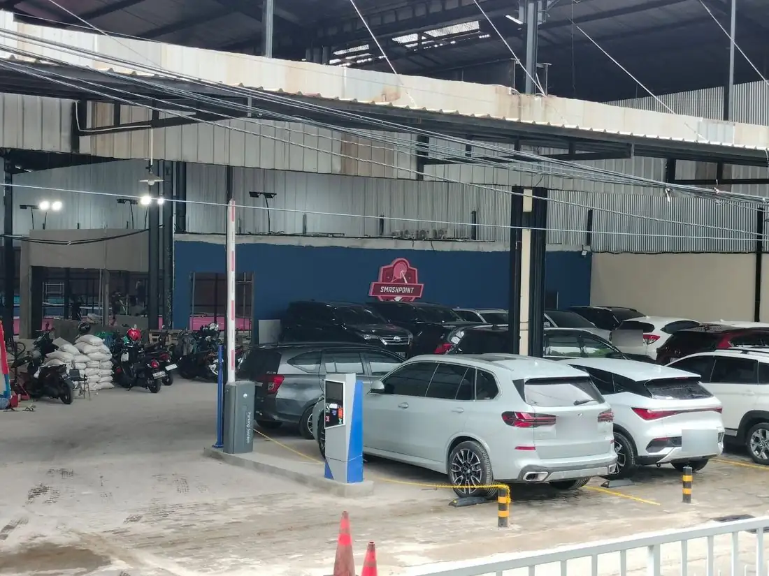 Gated parking area with the Smashpoint crest on the wall