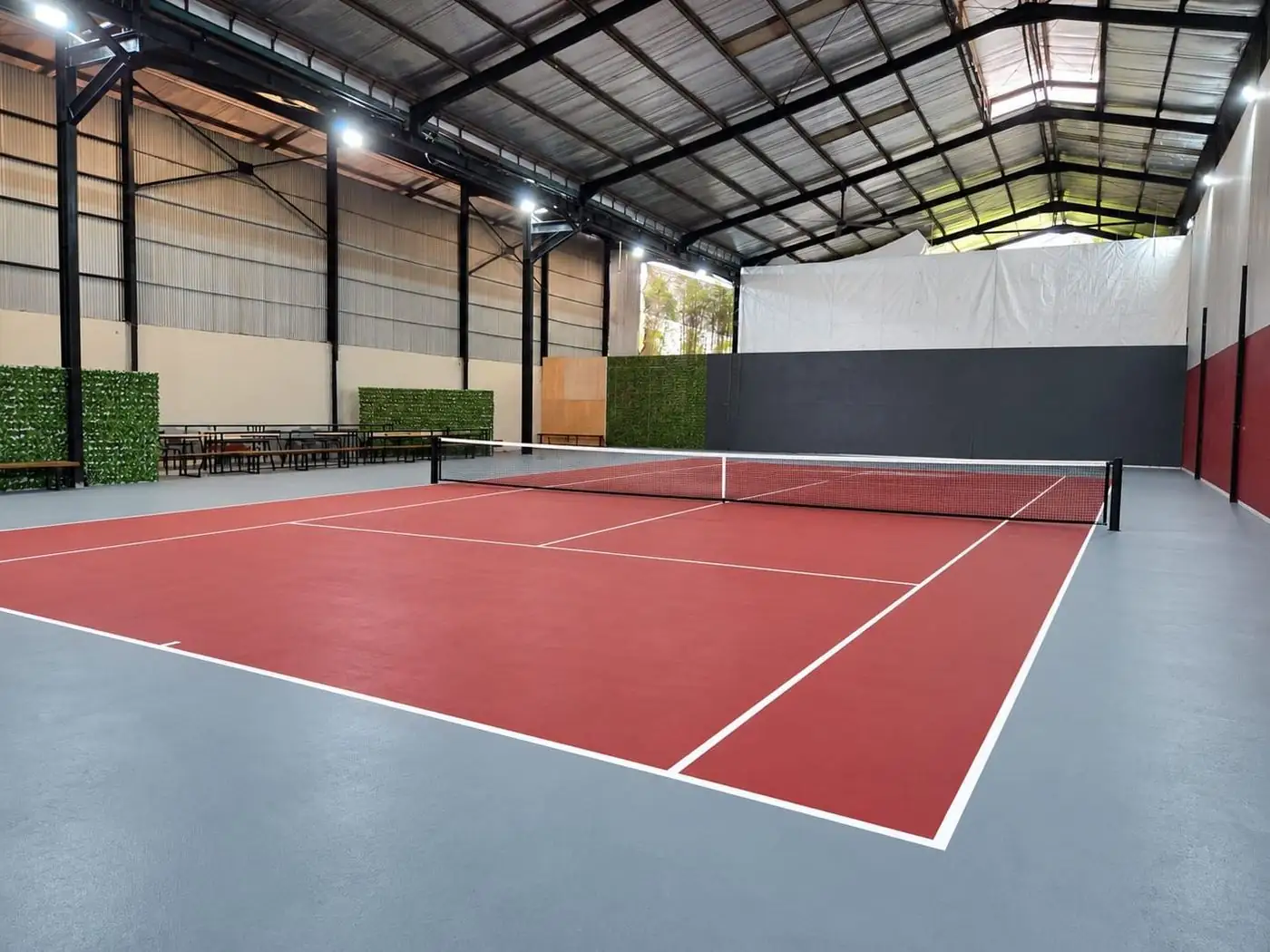 The red indoor tennis court at Smashpoint Sports Arena